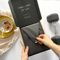 Person opening a black box with 'Take Care of You' text